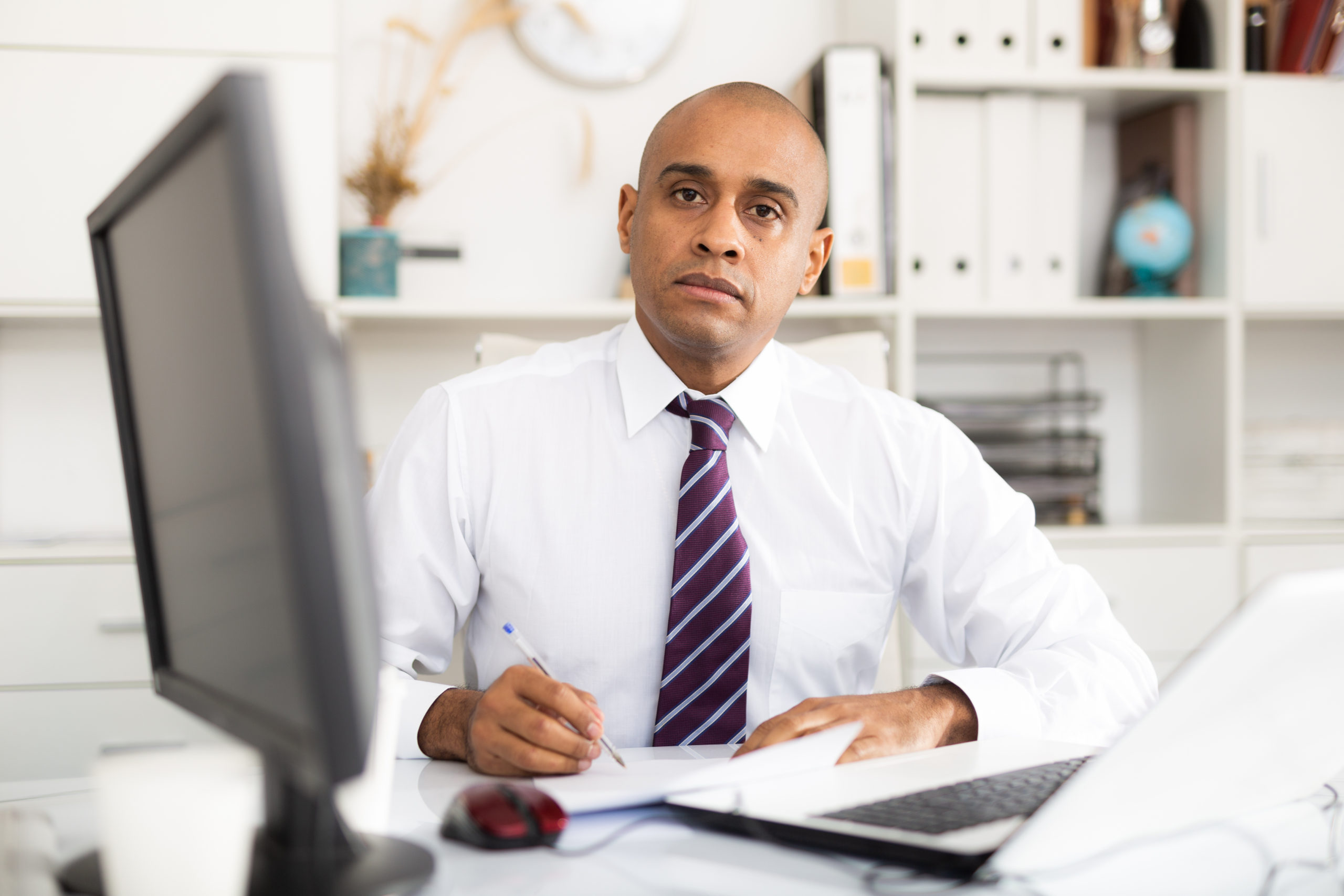 Professional business man using laptop at workplace in office